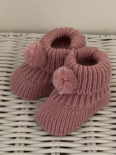 babies knitted pom pom bootees in dusky pink 